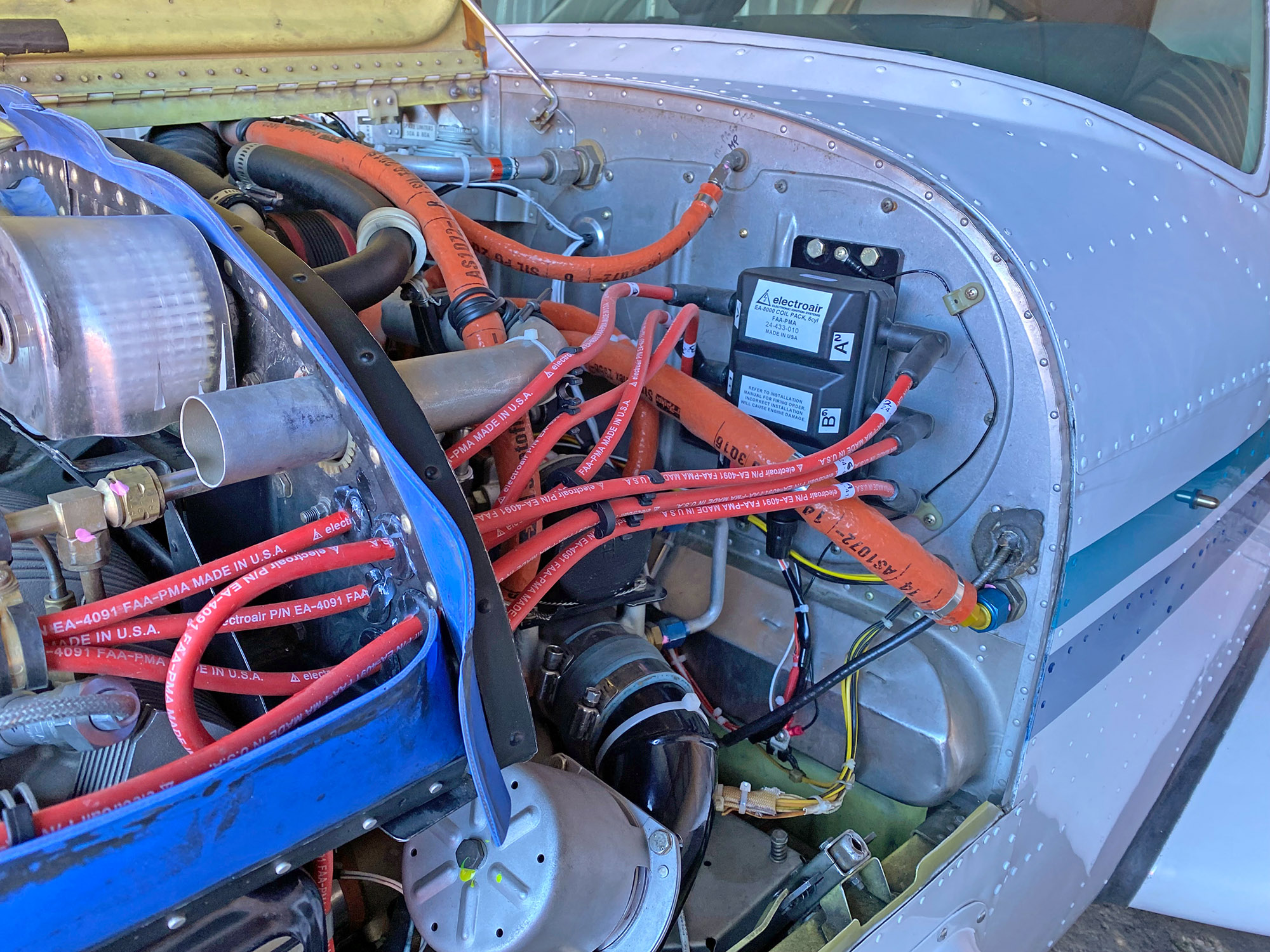 Electroair EIS and wiring on the Bonanza’s upper left area of the firewall, replacing the right magneto.