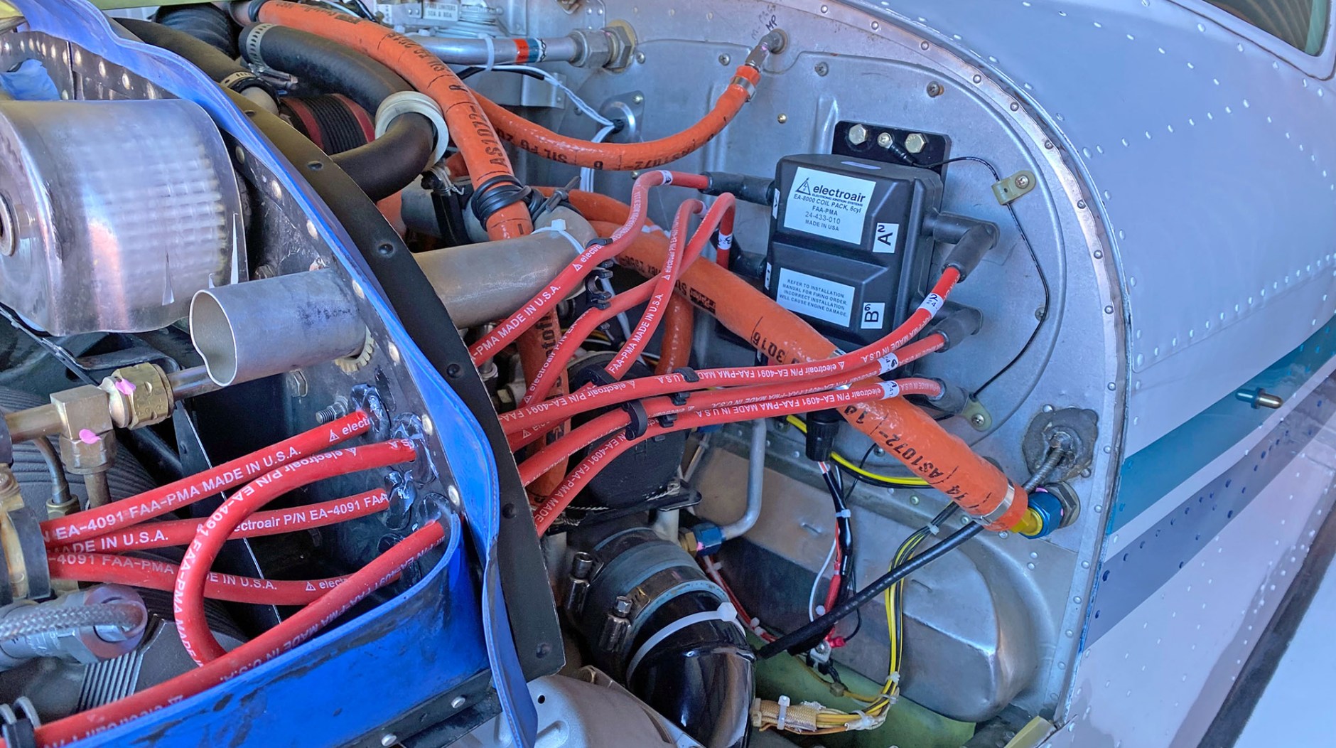 Electroair EIS and wiring on the Bonanza’s upper left area of the firewall, replacing the right magneto.
