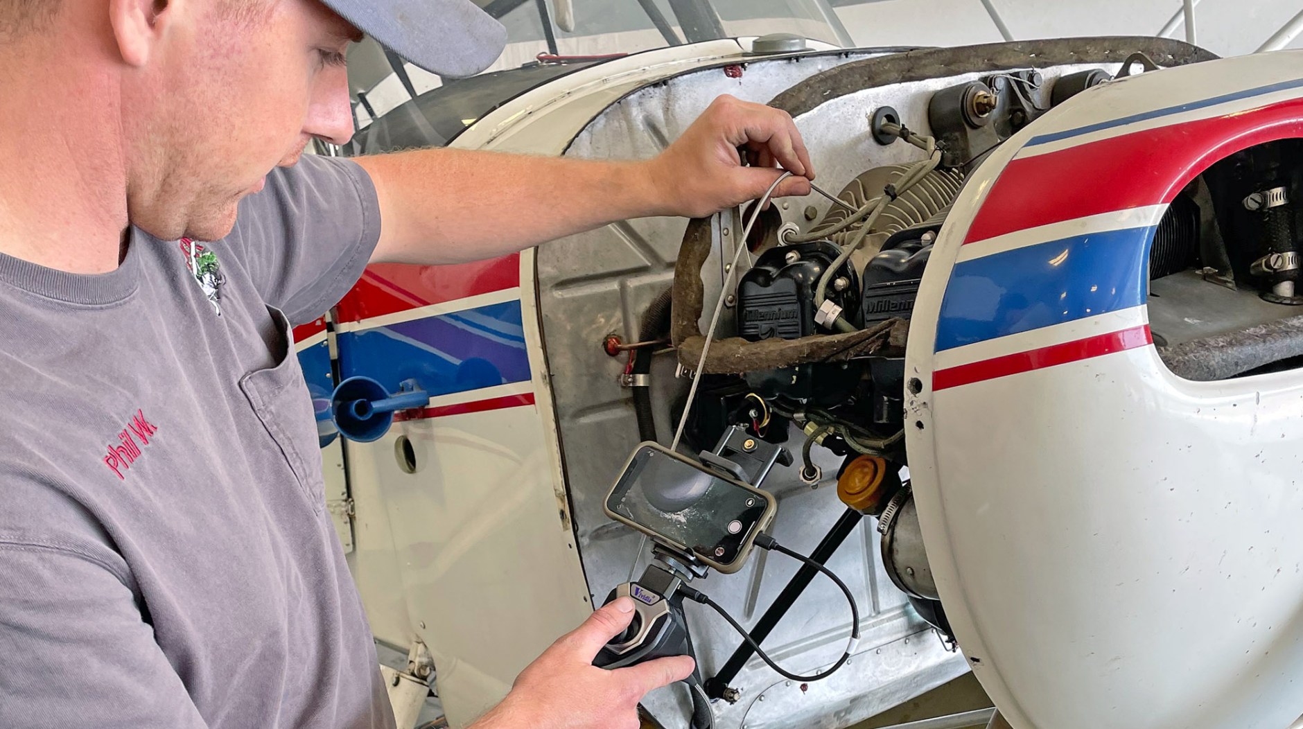 Savvy Borescope: A&P Phil Weaver of Northern Air Airmotive on the Boundary County, Idaho, airport using a Vividia CS-4010i borescope to examine a cylinder on an Aeronca Champ’s engine.